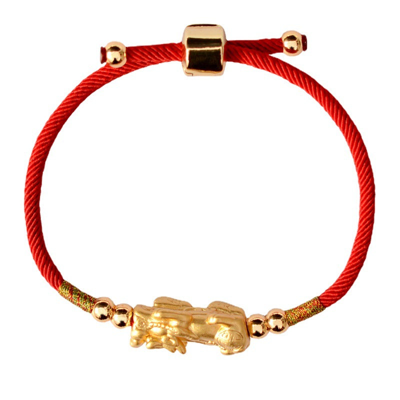 Gold plated Pixiu red string bracelet for wealth attraction, featuring a silver charm on a beaded cord.