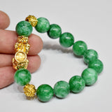 Dark jade stone bracelet with gold plated Pixiu charm, designed for wealth manifestation and energy magnetism.