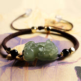 Green jade Pixiu wealth bracelet with black obsidian beads and dark cord for men, symbolic money attraction energy