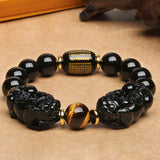 Men's and women's black obsidian beaded bracelet with a Pixiu, designed for wealth flow activation and financial energy protection.