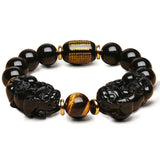 Black Obsidian Pixiu bracelet for wealth attraction, featuring a beaded design with a carved Pixiu charm for energy flow and manifestation.