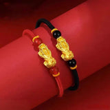 Red string bracelet with gold Pixiu charm, a feng shui wealth bracelet for couples to manifest money and good fortune
