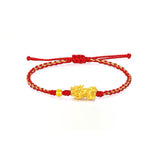 Gold Pixiu wealth attraction bracelet with red string, a symbolic Chinese charm for money energy flow and prosperity