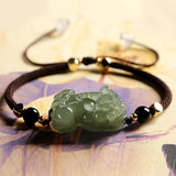 Green jade Pixiu bracelet with black obsidian beads for wealth attraction, a feng shui bracelet for men and women.