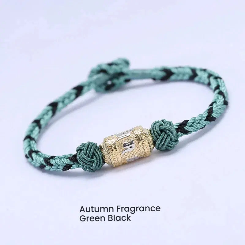 Green string bracelet with silver mantra charm for attracting luck and good fortune, a spiritual energy accessory for men and women.