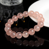 Beaded pink crystal bracelet for love manifestation, showcasing round beads in a gentle peach color.