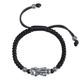 Vintage silver Pixiu wealth bracelet with black cord for men, a feng shui accessory for attracting wealth and good fortune