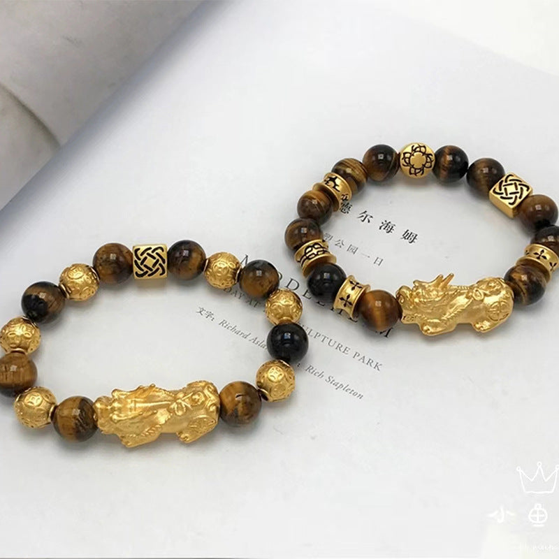 Beaded Tiger's Eye bracelet featuring a gold Pixiu charm for wealth attraction and energy