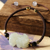 Decorative Feng Shui bowl with golden coins and gemstones for home decor