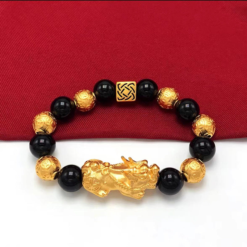 Men's black bead bracelet with a gold-plated Pixiu charm, a symbolic accessory for attracting wealth and prosperity