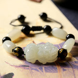 Jade Pixiu bracelet for wealth attraction, featuring a carved Pixiu charm and jade beads for energy flow.