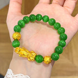 Feng Shui prosperity plant with metallic leaves and lucky charms