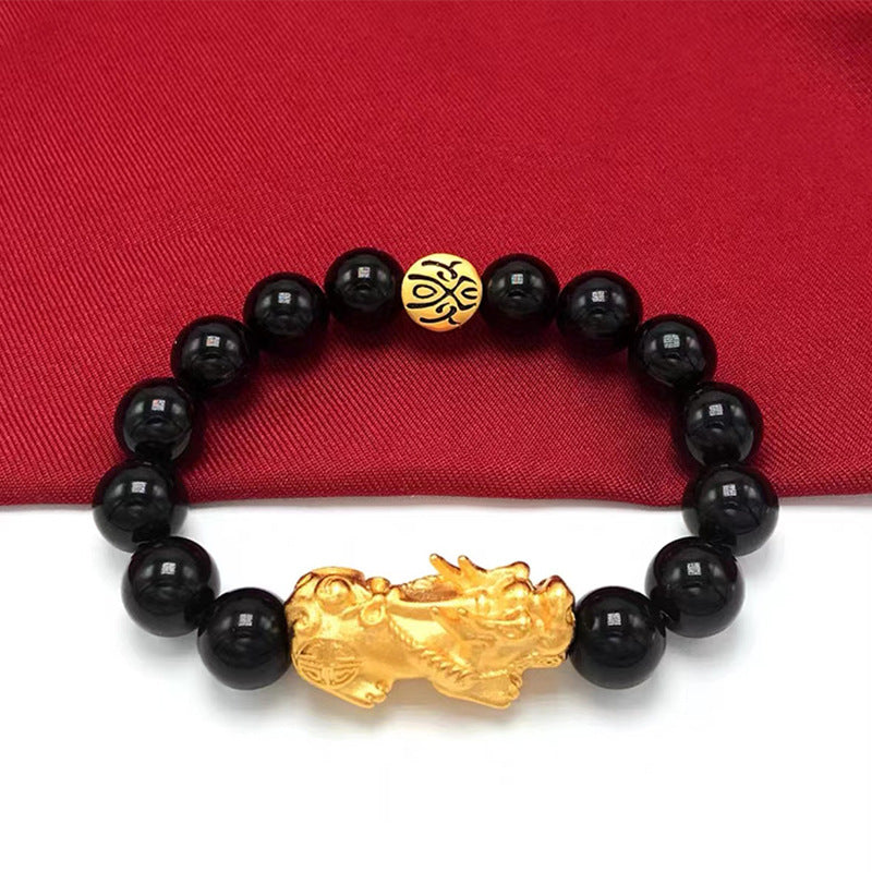 Black beaded men's bracelet with a detailed gold Pixiu charm, designed for wealth manifestation and energy