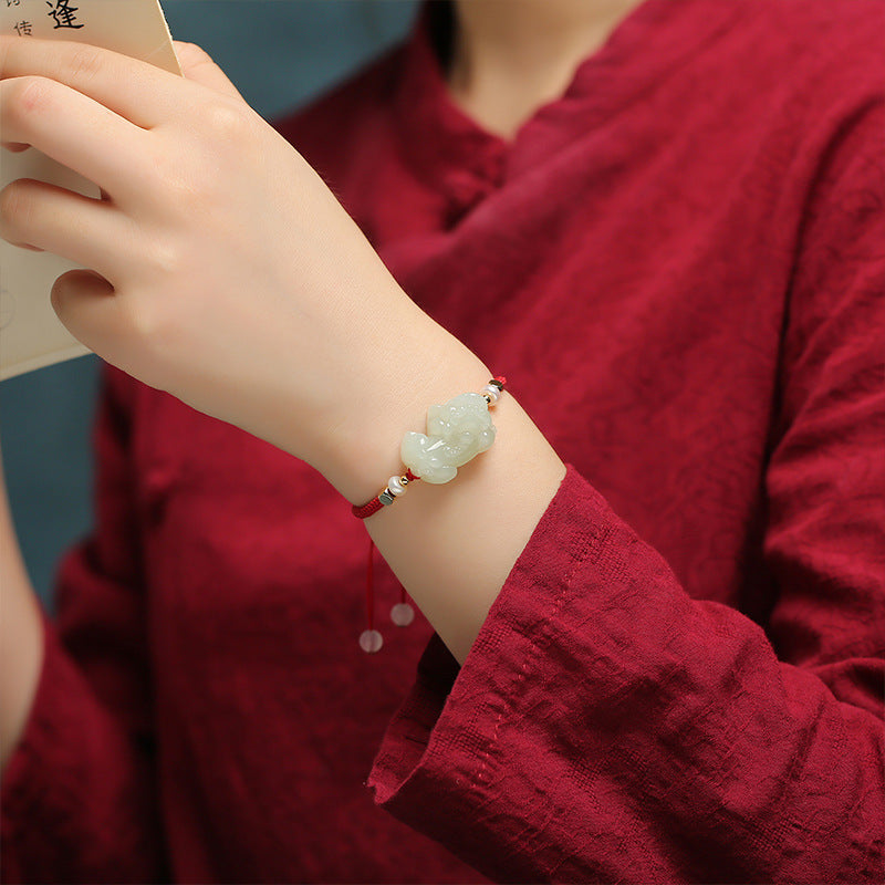 Wealth bracelet for men featuring a nephrite jade Pixiu, black obsidian beads, and classic red string design