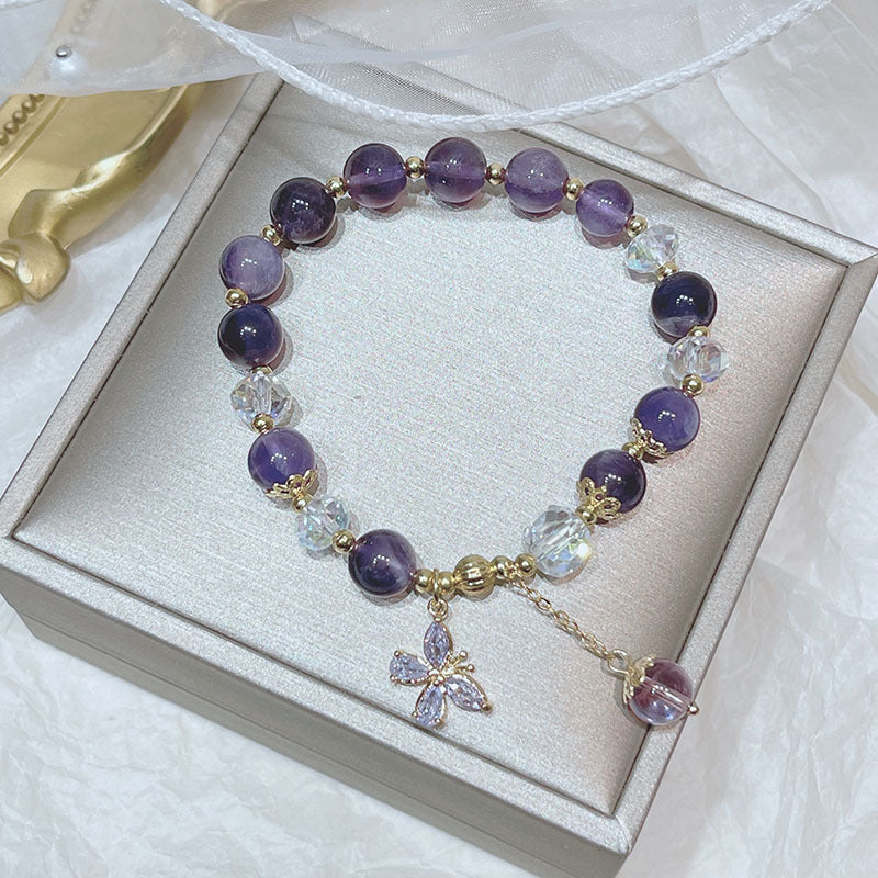 Beaded amethyst crystal bracelet featuring a butterfly detail, a crystal accessory for emotional harmony
