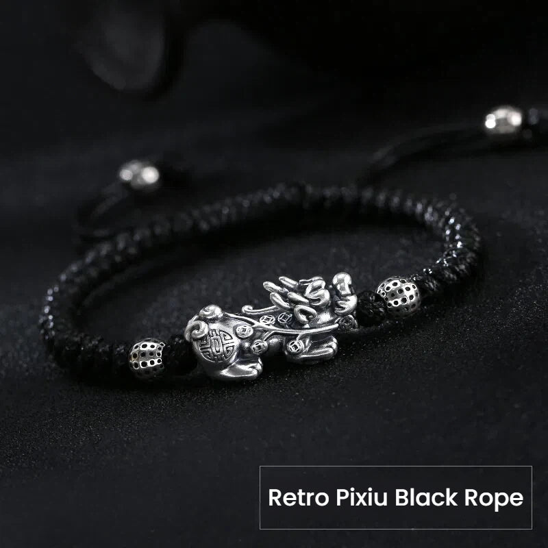 Men's beaded bracelet with silver Pixiu charm on black string, a symbolic feng shui piece for wealth manifestation