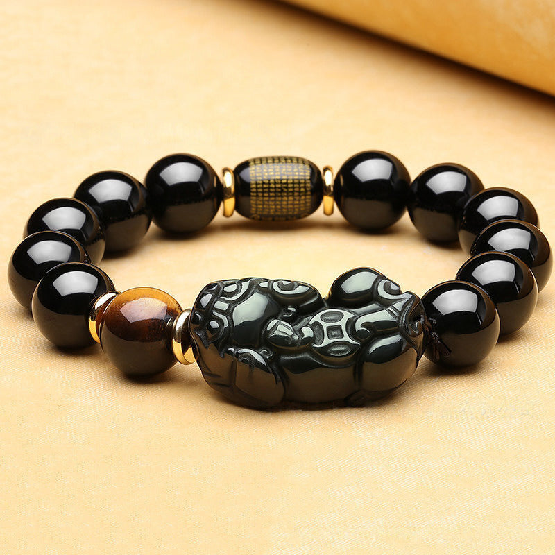 Obsidian stone bracelet with Pixiu charm, a symbolic accessory for wealth attraction and stabilizing money energy field.