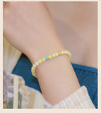 Turquoise crystal bracelet designed for good fortune, showcasing natural green gemstones in a beaded form.