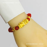 Red agate crystal bracelet with a gold plated Pixiu, designed for wealth energy and symbolic meaning in spiritual practice.