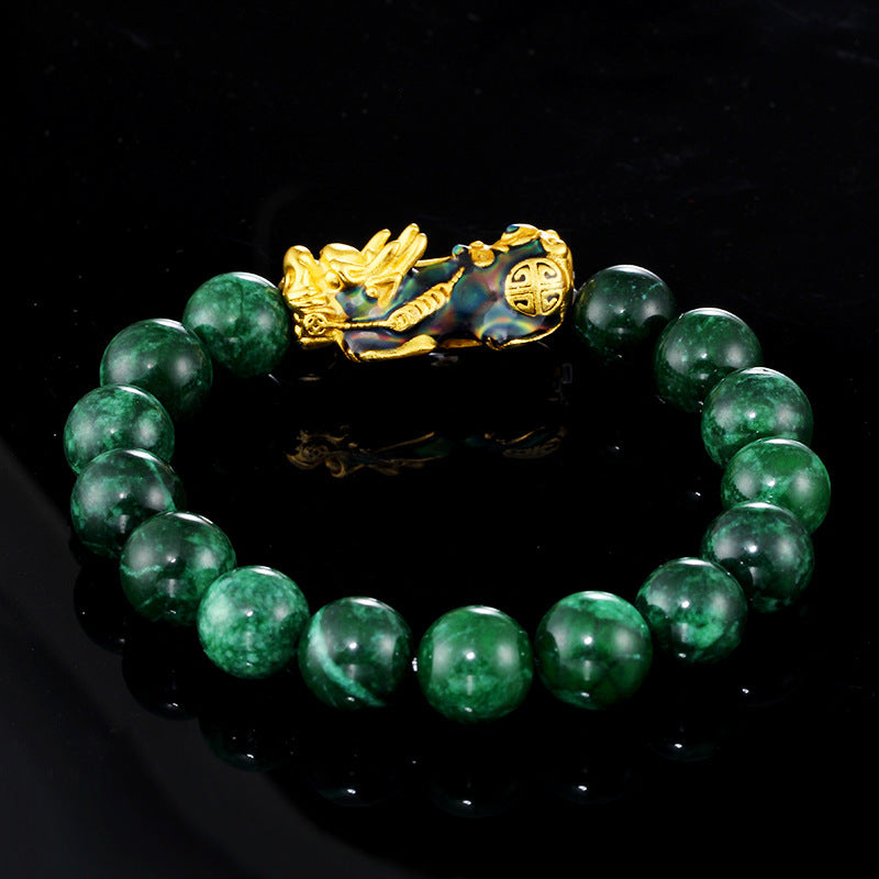 Beaded bracelet with green jade stones, gold plated Pixiu charm, and dark jade beads for wealth attraction and energy.