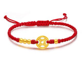 Red string bracelet with gold coin charm for wealth attraction, a symbolic Feng Shui accessory for money energy flow.