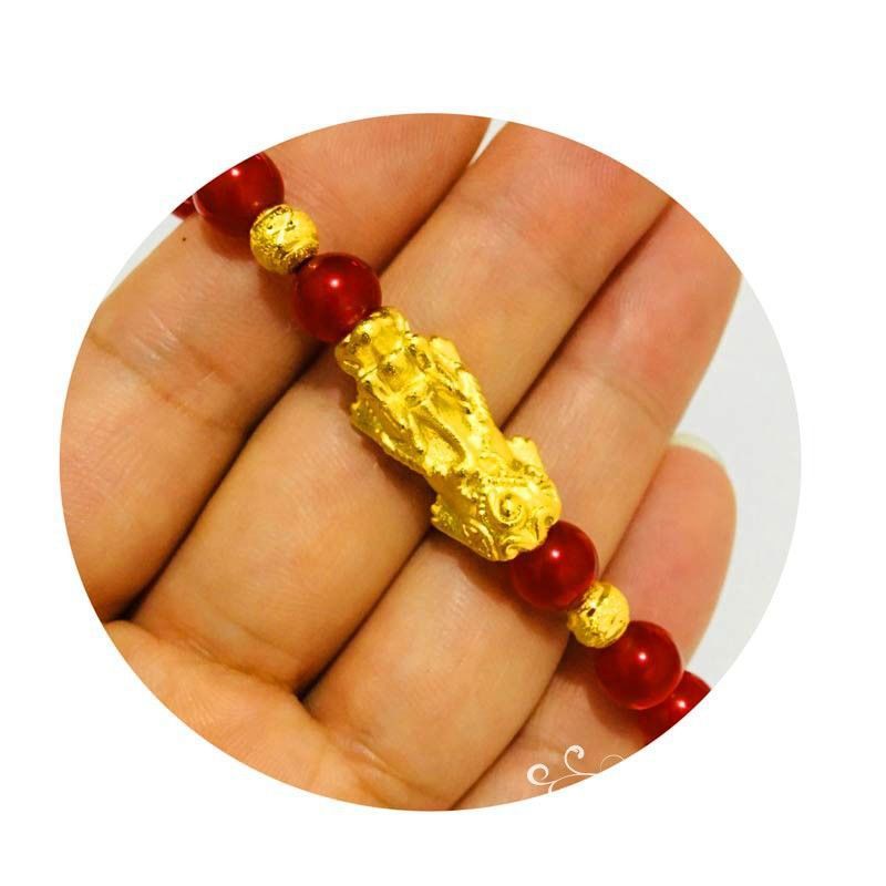 Gold plated Pixiu wealth bracelet with red agate beads, combining natural stone and symbolic charm for abundance.