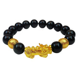 Wealth attraction bracelet made of black obsidian beads and a detailed gold-plated Pixiu charm.