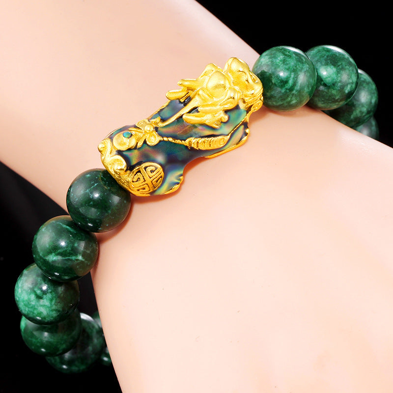 Beaded bracelet made of green jade and color-changing stones, designed with a gold plated Pixiu charm to attract wealth.