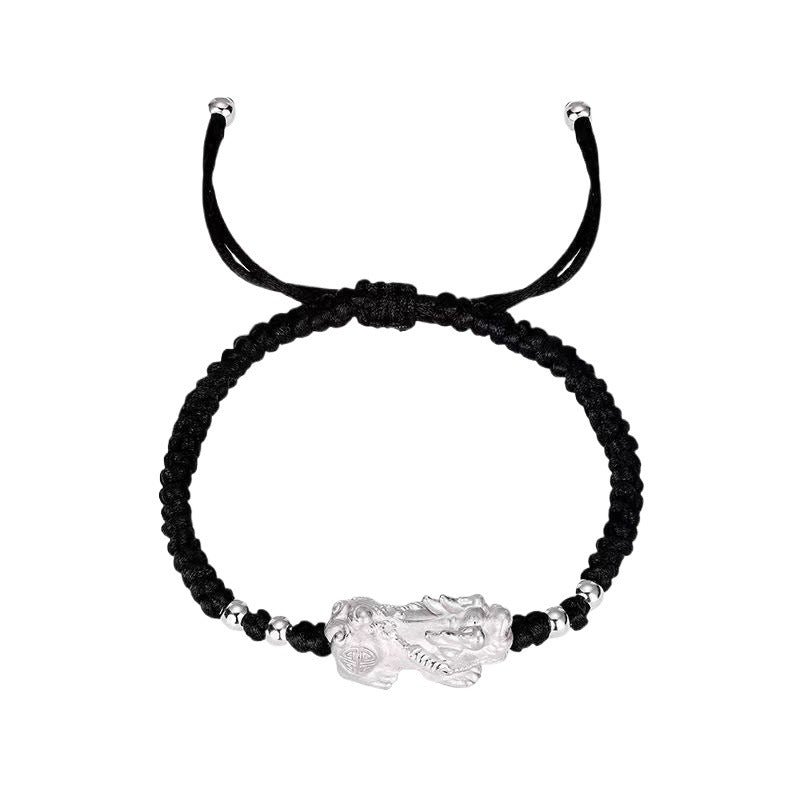 Black string bracelet with silver plated Pixiu charm, a feng shui accessory for attracting wealth