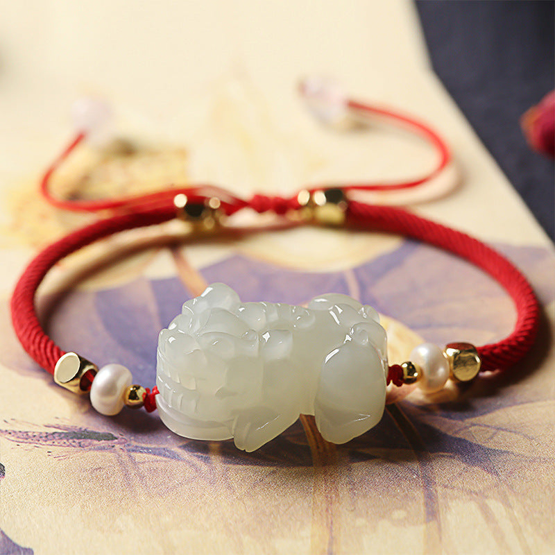 Men's beaded bracelet with nephrite jade Pixiu charm, black obsidian stones, and red string for wealth manifestation