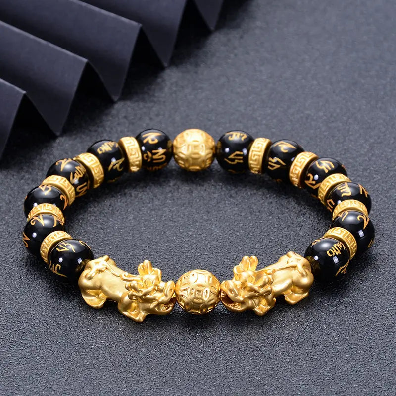Men's black agate beaded bracelet with gold plated Pixiu charm for wealth manifestation and good fortune.