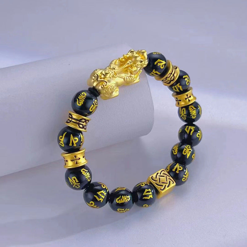 Gold Pixiu charm on a Tiger's Eye stone beaded bracelet for wealth manifestation