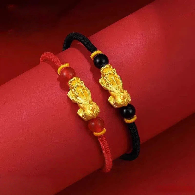 Red string bracelet with gold Pixiu charm for wealth manifestation, a beaded energy accessory for couples.