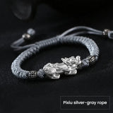 Silver Pixiu wealth bracelet with silver gray cord for men, a feng shui bracelet for wealth attraction and money flow